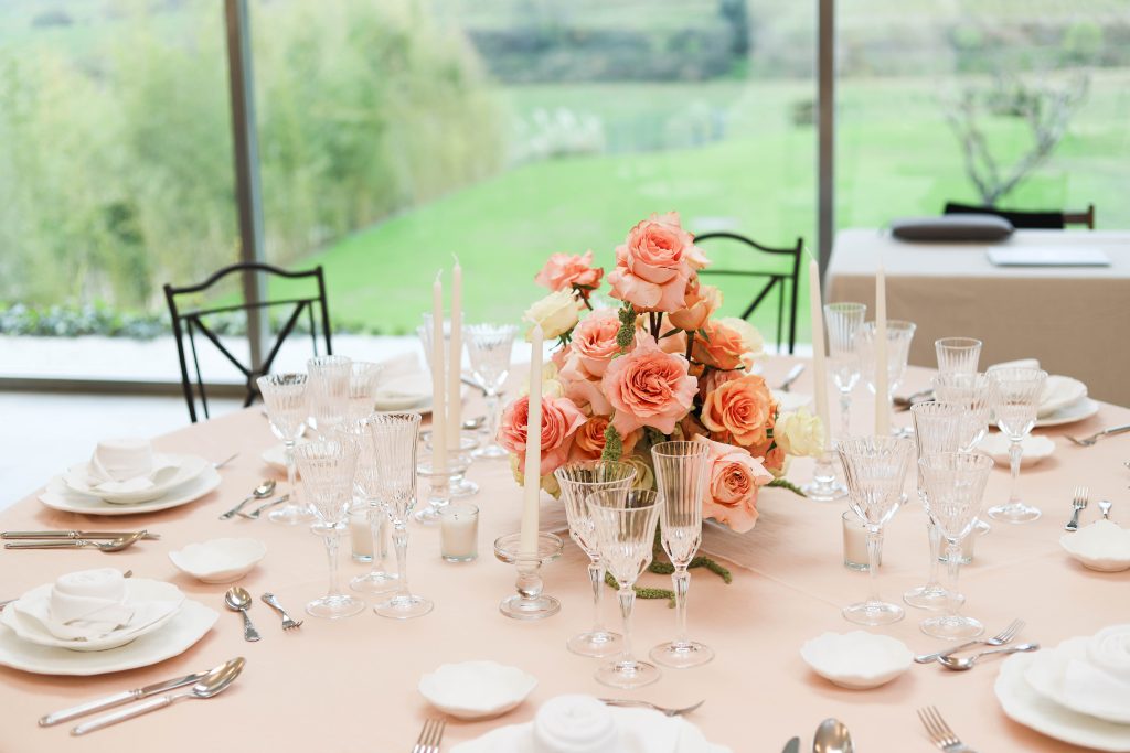 Luxury wedding planner Barcelona creating elegant wedding setup with flowers and candles